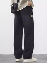 Men’s plus size wide leg black denim jeans with relaxed fit and tan patch on thigh in plus size wide style