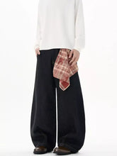 Black plus size wide-leg denim jeans with a detachable plaid scarf tied at the waist