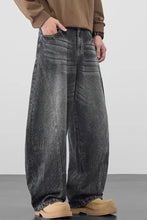 Men’s plus size wide leg wash jeans in black denim with faded distressed finish and visible stitching details