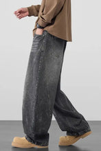 Men’s plus size wide leg wash jeans in dark gray denim with faded distressed texture and visible stitching details