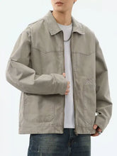 Beige plus size utility trucker jacket with zipper front, two chest pockets, and two lower patch pockets for men