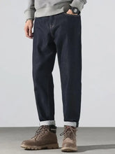 Men’s dark indigo denim pocketed loose fit jeans with rolled cuffs offering all-day comfort and relaxed fit