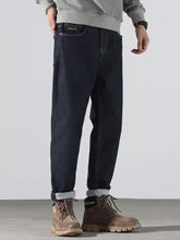 Men’s dark indigo denim pocketed loose fit jeans with a relaxed fit and rolled cuffs for all-day comfort