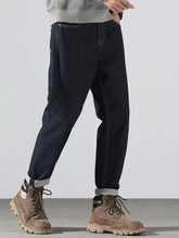 Men’s dark indigo denim pocketed loose fit jeans with relaxed fit and rolled cuffs for all-day comfort