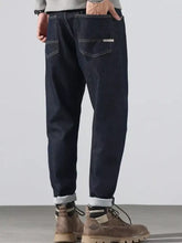 Men’s dark indigo denim pocketed loose fit jeans with relaxed fit rolled cuffs for all-day comfort