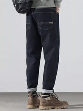 Men’s dark indigo denim pocketed loose fit jeans with relaxed fit and rolled cuffs for all-day comfort