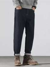 Men’s dark-wash denim pocketed loose fit jeans with relaxed fit and rolled cuffs for all-day comfort
