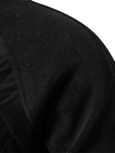 Men’s black quilted snap long sleeve jacket sleeve with soft textured fabric and subtle stitching details