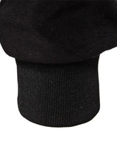 Black suede cuff with ribbed knit wristband on men’s quilted snap long sleeve jacket for added comfort and style
