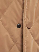 Men’s tan quilted snap long sleeve jacket featuring diamond stitching and contrasting black snap buttons