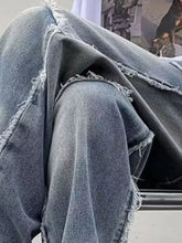 Men’s distressed dark wash denim raw hem wide leg jeans with frayed raw hem edges
