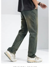 Men’s relaxed fit jeans in dark green faded denim with a relaxed fit and straight leg cut