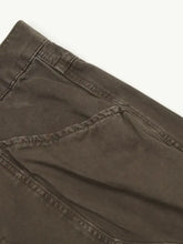 Men’s relaxed fit jeans in dark olive green cotton with subtle textured weave and reinforced seam stitching