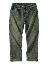 Men’s dark-wash denim relaxed fit jeans with rolled cuffs showcasing a comfortable and stylish fit design