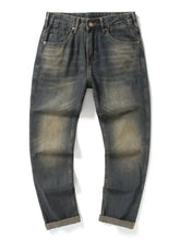 Men’s relaxed fit jeans in dark-wash denim with faded distressed areas and rolled cuffs feature comfort and style