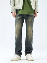 Men’s relaxed fit jeans in dark-wash denim feature a faded distressed look with frayed cuffs