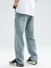Men’s relaxed fit jeans in light-wash denim with a fabric blend and subtle fading along the thighs for comfort and style