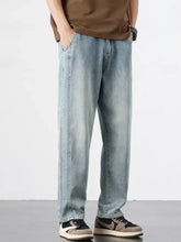 Men’s relaxed fit light-wash denim jeans with a straight-leg cut and subtle fading for a casual modern look