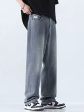 Men’s relaxed fit straight leg jeans made of gray denim with wide-leg cut and subtle fading for casual wear