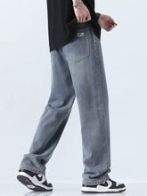 Men’s relaxed fit straight leg jeans in light wash denim with subtle fading and a relaxed straight-leg cut