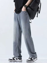 Men’s relaxed fit straight leg jeans in light-wash denim with subtle fading for a casual modern look