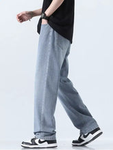 Men’s relaxed fit straight leg jeans in light-wash denim showcasing a relaxed, straight-leg cut for casual wear
