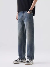 Men’s relaxed fit vintage wash jeans in blue denim with a straight-leg cut and subtle fading for a casual look