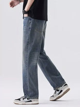 Men’s relaxed fit vintage wash jeans in blue denim with a straight leg cut and subtle fading