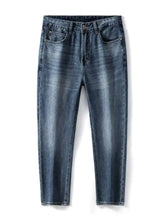 Men’s relaxed fit dark-wash denim jeans with classic five-pocket design and subtle fading for a worn-in look