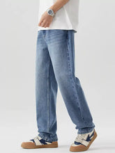 Men’s relaxed fit wash jeans in light-wash blue denim with a relaxed straight-leg cut