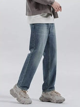 Men’s relaxed fit wash jeans in light-wash blue denim with a straight-leg cut and subtle fading for casual wear