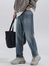 Men’s relaxed fit wash jeans in washed blue denim with a relaxed straight-leg cut