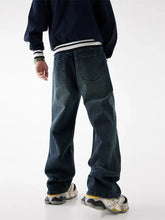 Men’s relaxed fit washed dark-wash denim jeans with a relaxed straight-leg cut and classic back pockets shown from the back