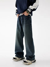 Men’s relaxed fit washed dark-wash denim jeans with a relaxed straight-leg cut and visible stitching details