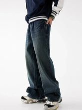 Men’s relaxed fit washed jeans in dark-wash denim with a relaxed wide-leg cut and subtle fading