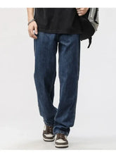 Men’s dark blue denim jeans with a relaxed fit, wide leg, straight-leg cut, and classic stitching