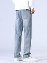 Men’s light-wash denim jeans with a relaxed fit wide leg and classic back pockets shown from the back side