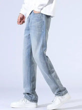 Men’s light-wash denim jeans with relaxed fit wide leg and visible stitching along the seams