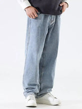 Men’s relaxed fit wide leg jeans in light-wash denim with a relaxed straight leg cut and visible stitching details