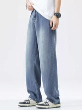 Men’s relaxed fit wide leg jeans in light-wash blue denim with a vintage wash and relaxed wide-leg cut