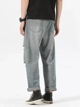 Men’s light-wash denim ripped relaxed fit jeans with rolled cuffs and subtle distressing for casual wear