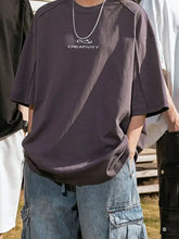 Mens round neck basic style half sleeve oversized t-shirt with silver chain and denim shorts