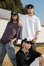 Three young adults modeling mens round neck basic style half sleeve oversized t-shirts