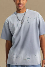 Light blue mens round neck half sleeve t-shirt with colorful paint splatters