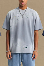 Mens round neck half sleeve t-shirt in light blue with black paint splatters