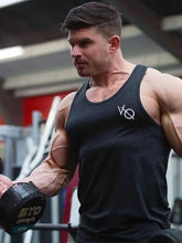 Muscular man in slightly stretchy mens round neck racerback tank doing bicep curls