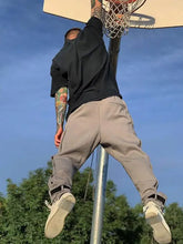 Person in basic style button pants dunking basketball, machine wash