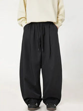 Loose-fitting black ruched wide leg pants with drawstring waist