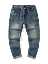 Men’s slim fit blue denim jeans with faded wash and rolled cuffs showcasing a stylish slim fit design
