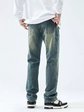 Men’s slim fit jeans in distressed blue denim with faded wash and classic five-pocket design for stylish fit jeans